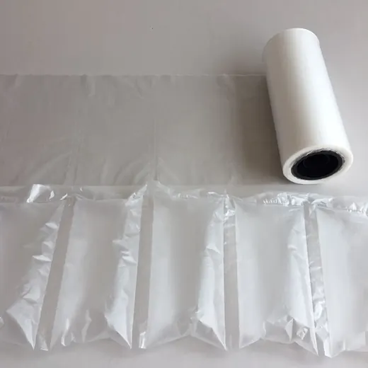 Roll of transparent air cushion packaging film with inflated air pillow cushions on a white surface