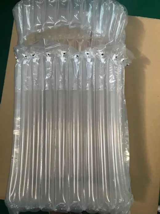 Inflated clear air cushion packaging wrap lying on a cardboard box