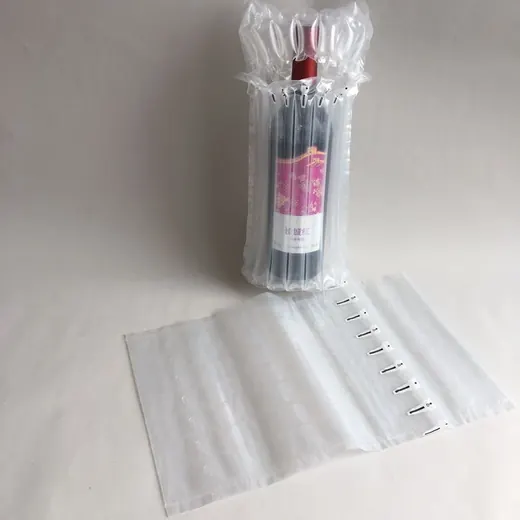 A bottle wrapped in a clear air cushion bag standing next to a deflated bag on a white surface.