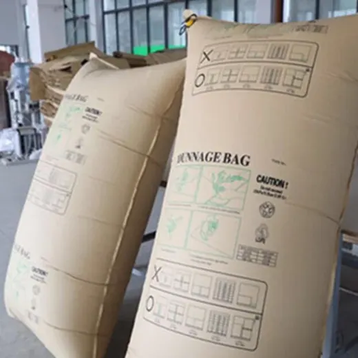 Two large kraft paper dunnage bags printed with handling instructions standing in a warehouse