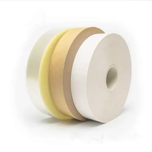 Stacked rolls of white and tan adhesive tape with a yellow foam layer on a white background