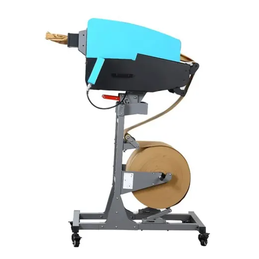 Industrial machine with a cardboard reel and cyan housing on a wheeled stand.
