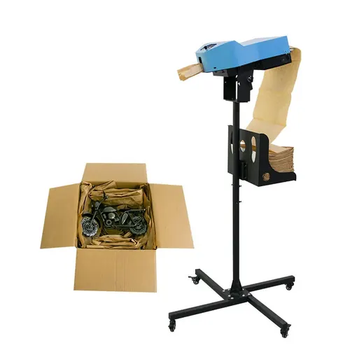 Packaging machine dispenses paper into a box containing a motorcycle model.