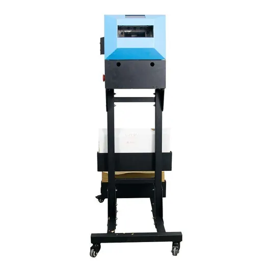 Vertical packaging machine with a blue and black head on a tall stand holding a cardboard box.