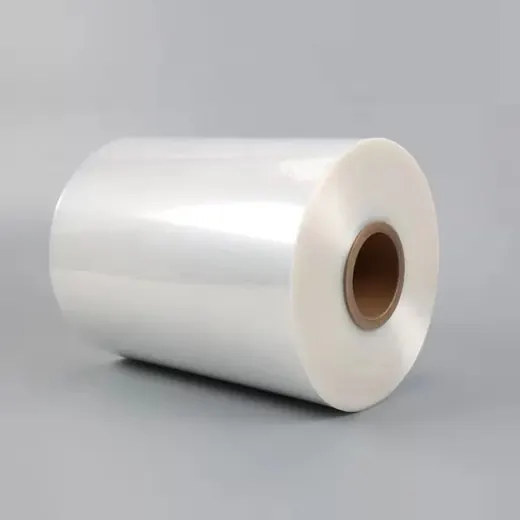 Roll of transparent plastic film with cardboard core on a plain gray background