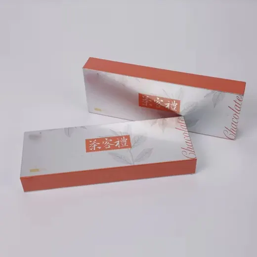 Two rectangular packaging boxes with silver tops and orange sides, featuring Chinese characters and the word Chocolate