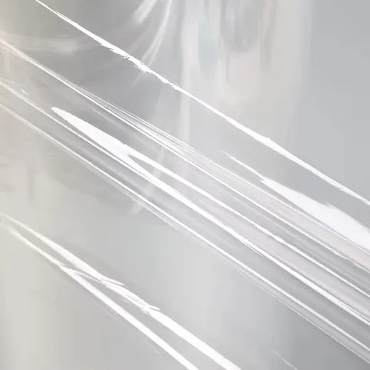 Close-up of translucent plastic film with diagonal creases and light reflections