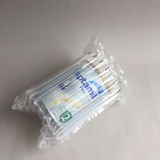 A bundle of infant formula tins protected by clear inflatable air cushion packaging.