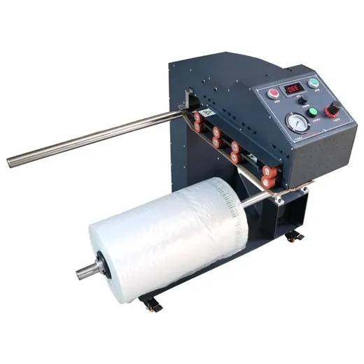 Industrial machine with a control panel and a large roll of clear plastic film on a spindle.