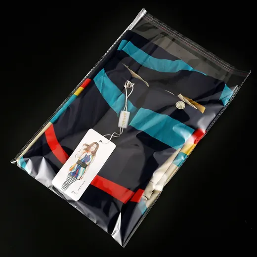Striped folded shirt inside a clear plastic ziplock bag with a hang tag attached