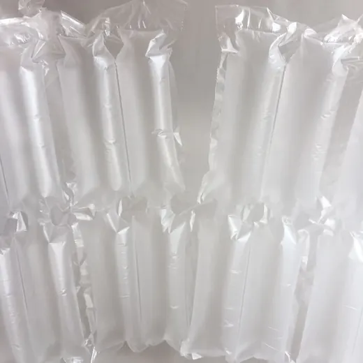 Close-up of inflated transparent plastic air pillow packaging cushions against a plain light background