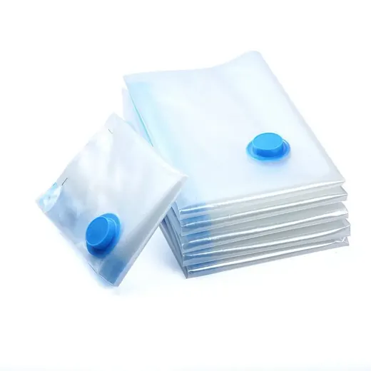 Stack of transparent vacuum storage bags with blue valve caps on a white background