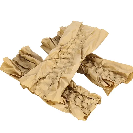 Crumpled kraft paper cushioning strips used as protective packaging void fill on white background