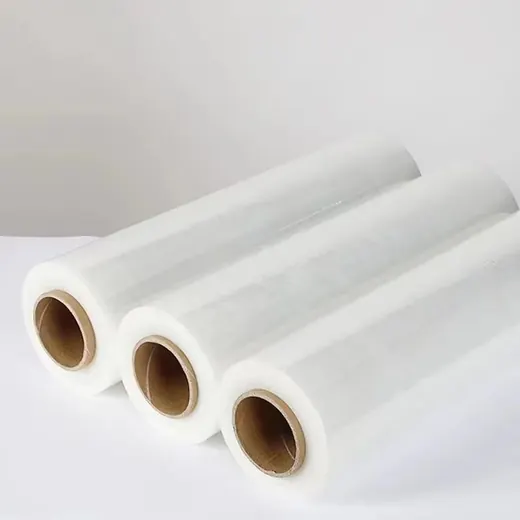 Three rolls of clear stretch wrap film with cardboard cores arranged diagonally on a white surface
