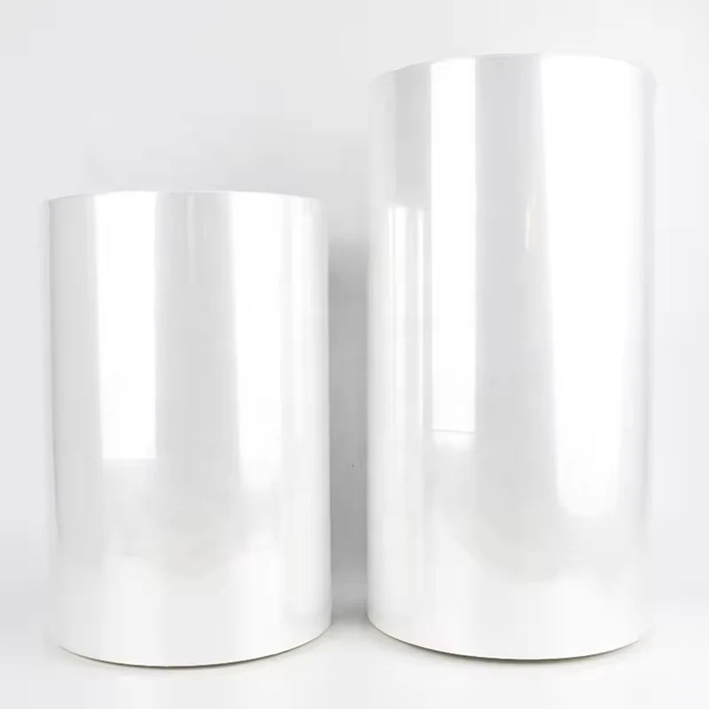 Two large upright rolls of clear plastic film against a plain white background