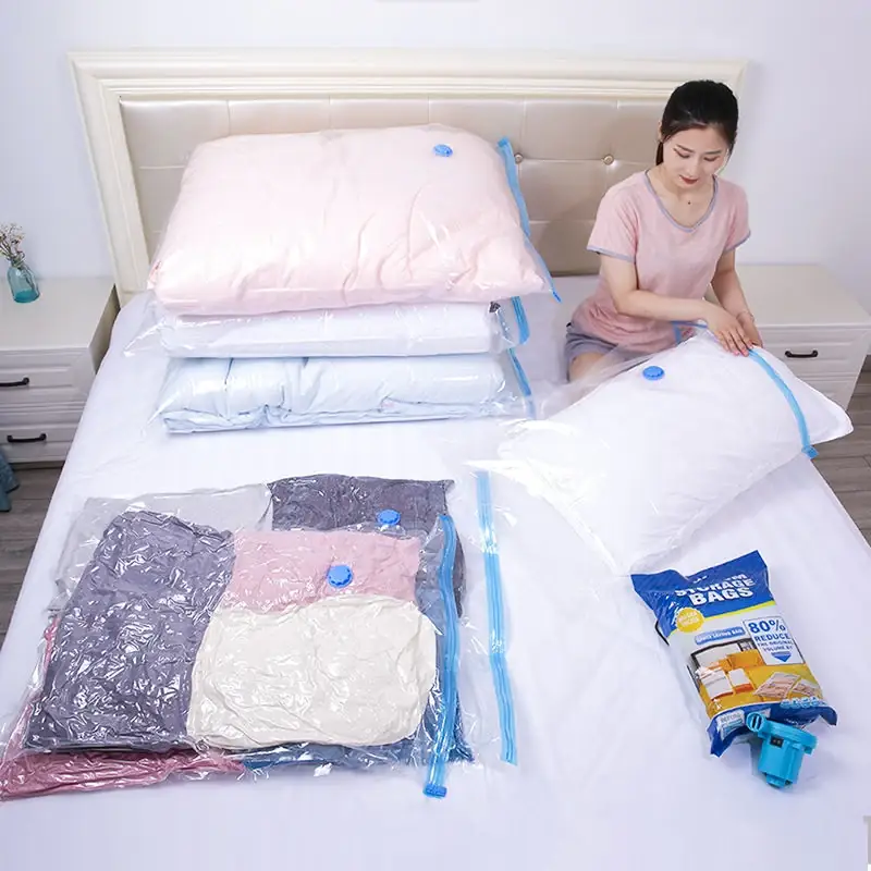 Woman sitting on a bed demonstrating vacuum storage bags filled with pillows and clothing alongside a small blue pump.