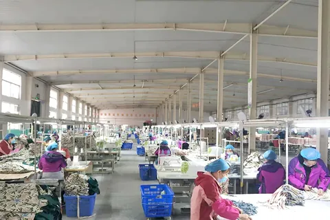 Inspection and sorting area with workers checking finished bags