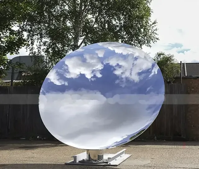 A large reflective parabolic dish antenna mounted outdoors on a base.