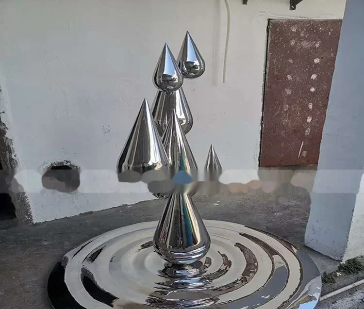 Polished stainless steel sculpture with multiple cone shapes on a circular base