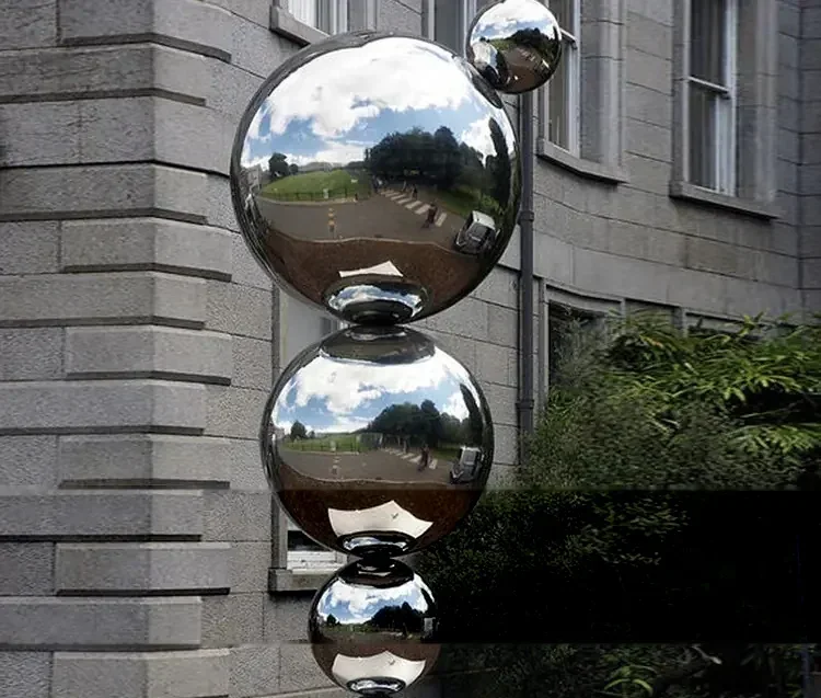 Stacked reflective metal spheres in an outdoor art installation
