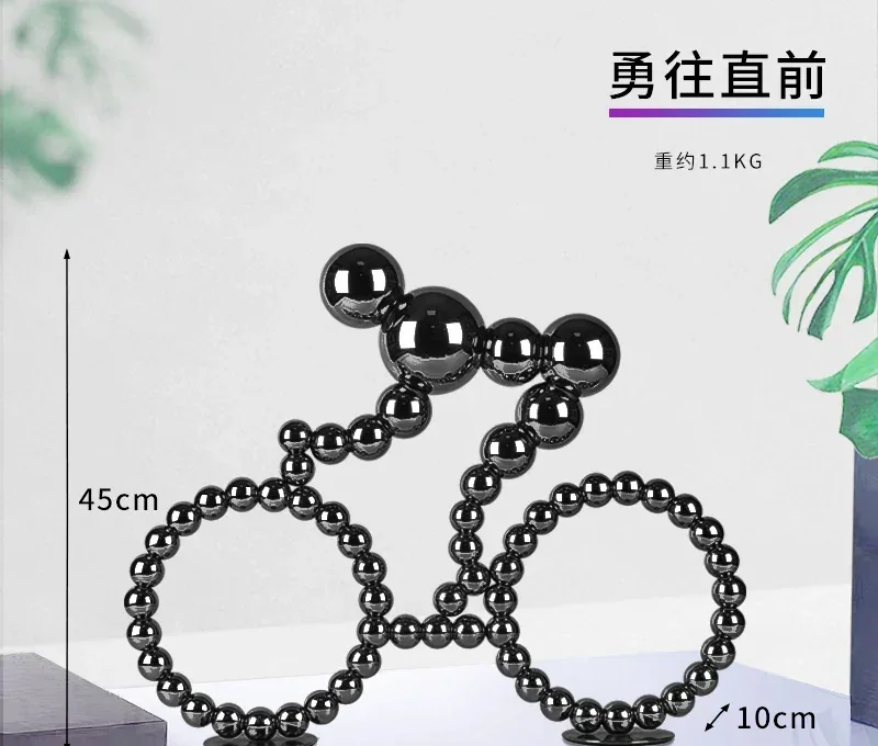Bicycle sculpture made of black magnetic balls with dimension markings
