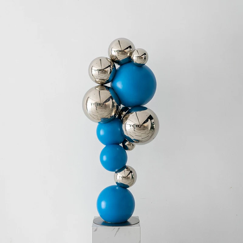 Stacked blue and mirror finished sculptural forms