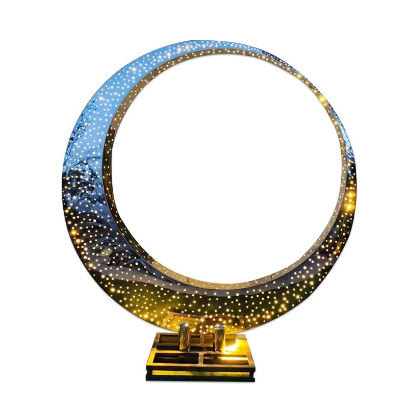 Polished crescent moon sculpture with perforated dot pattern, gold inner face, on stepped base