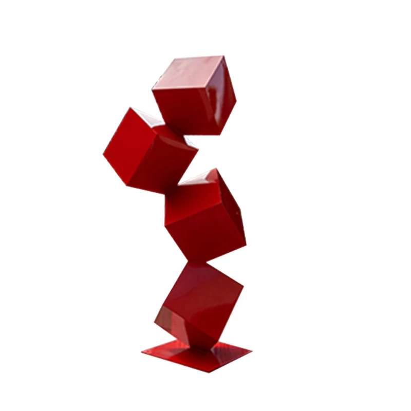 Red geometric sculpture of four balanced cubes on a white background