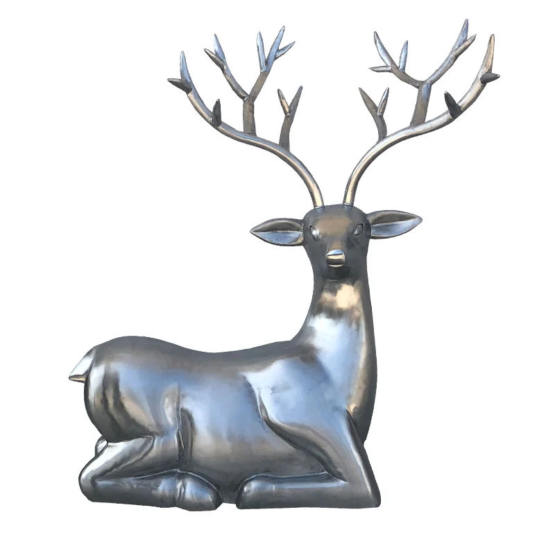 Silver metallic sculpture of a reclining deer with large antlers on a white background