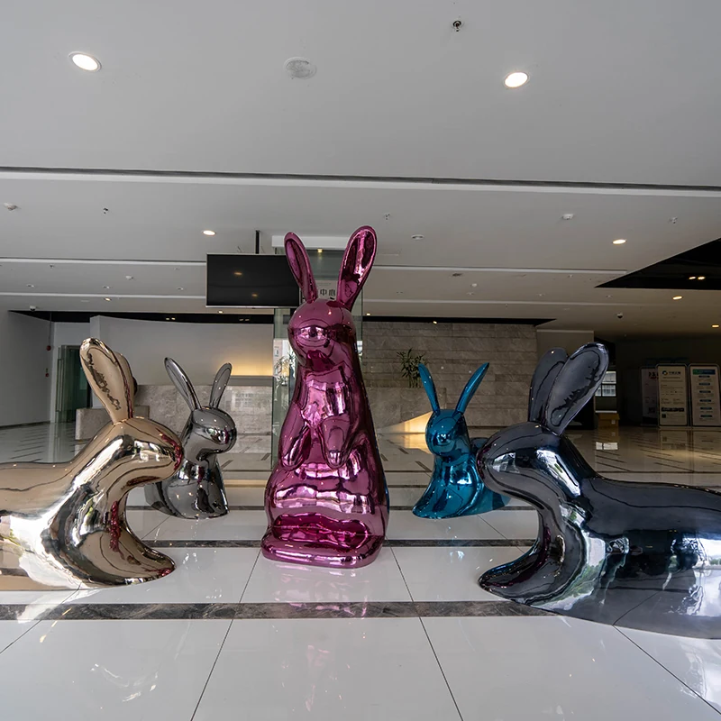 Polished rabbit sculptures grouped in a hotel lobby