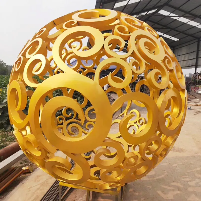 Golden spherical hollow art sculpture with openwork scroll pattern