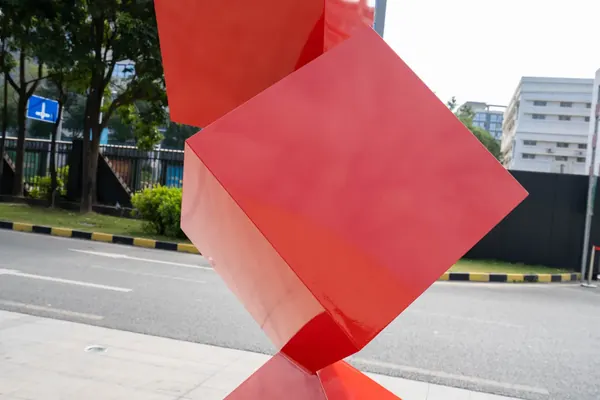Coloured geometric cube sculpture in a street setting