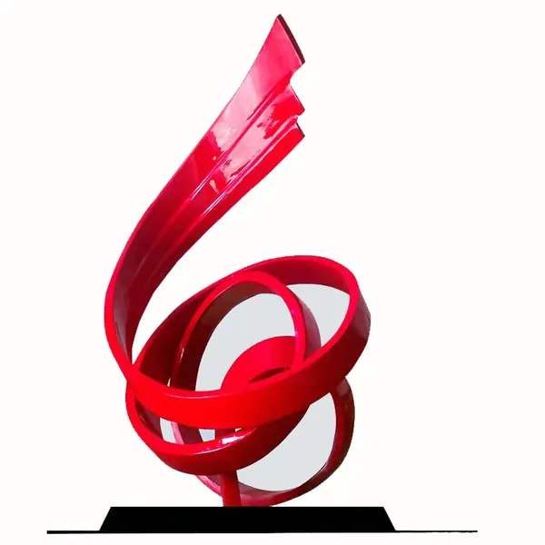 Glossy red abstract ribbon sculpture with a looping base and a rising twisted top.