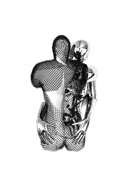 Close-up of a silver ring featuring two abstract figures embracing.