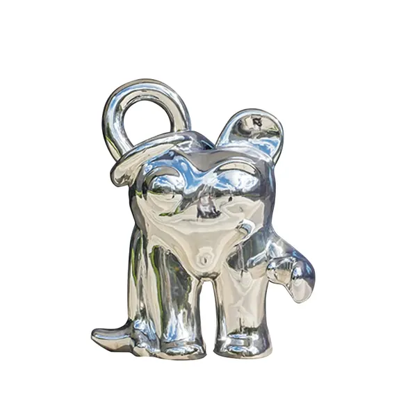 Silver metal figurine of a dog wearing a hat with a loop on top