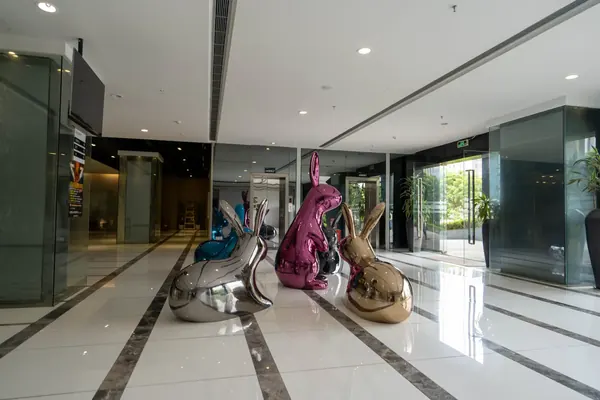 Group of polished hollow rabbit sculptures on display