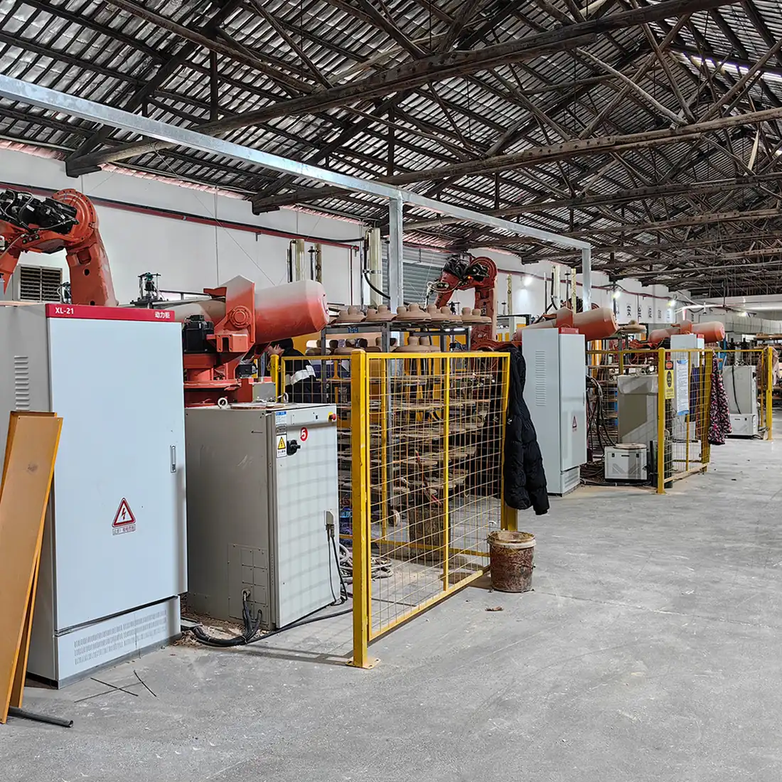 Robotic forming cells and drying racks of porcelain insulator bodies at the Baolifeng plant