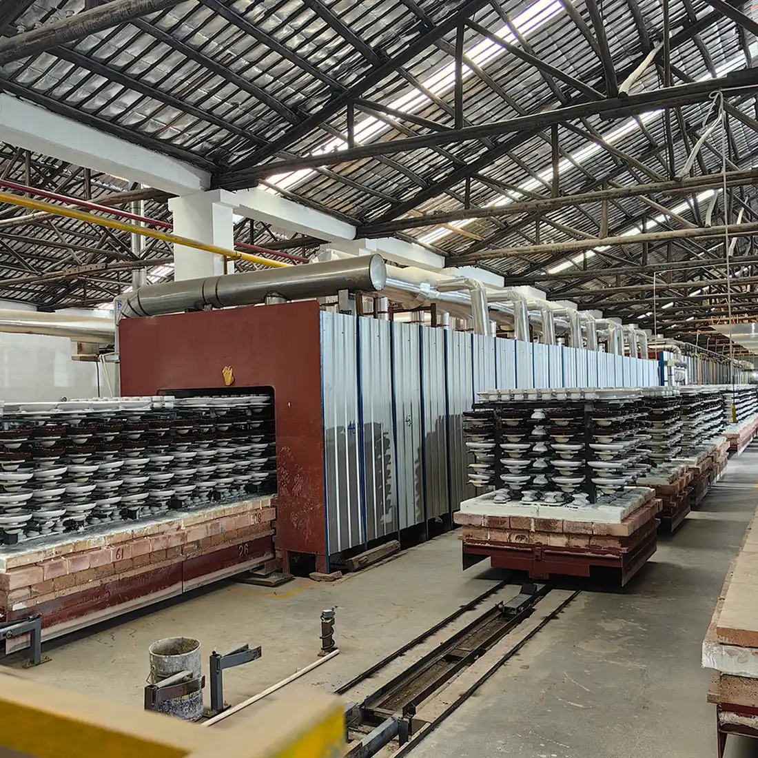 Tunnel kiln at the Baolifeng plant with kiln cars stacked with porcelain insulator shells