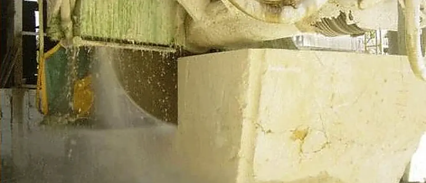 Marble block being cut with a diamond blade at the plant