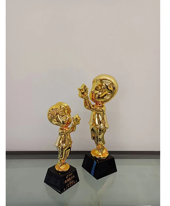 Two gold plated 3D cast trophy figures on black engraved plinths