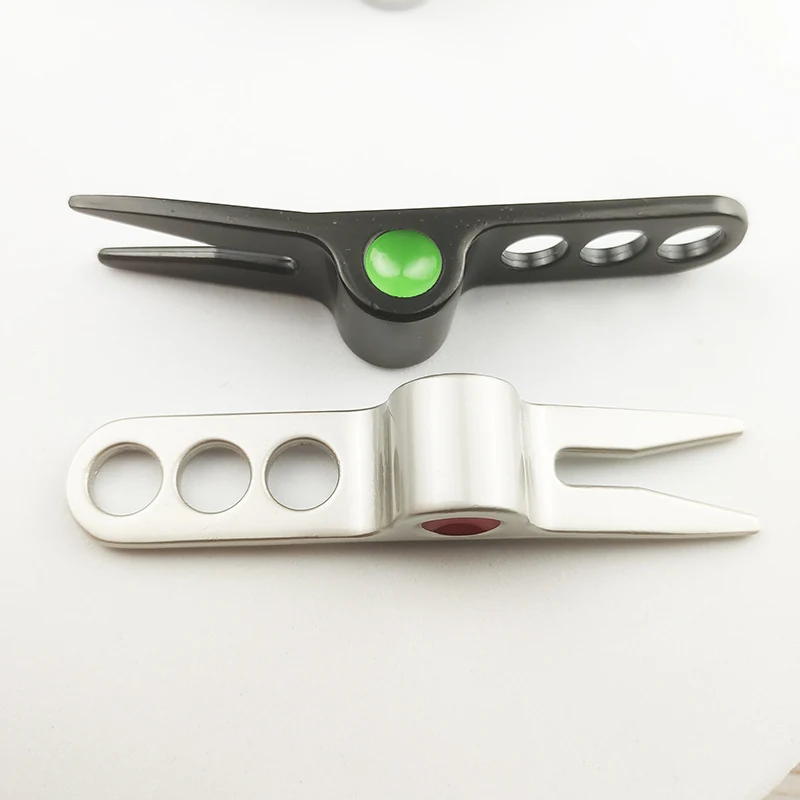 Black and silver divot tools shown together