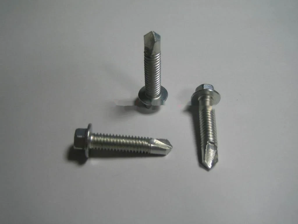 Hex washer head and countersunk self drilling screws on a steel grey ground