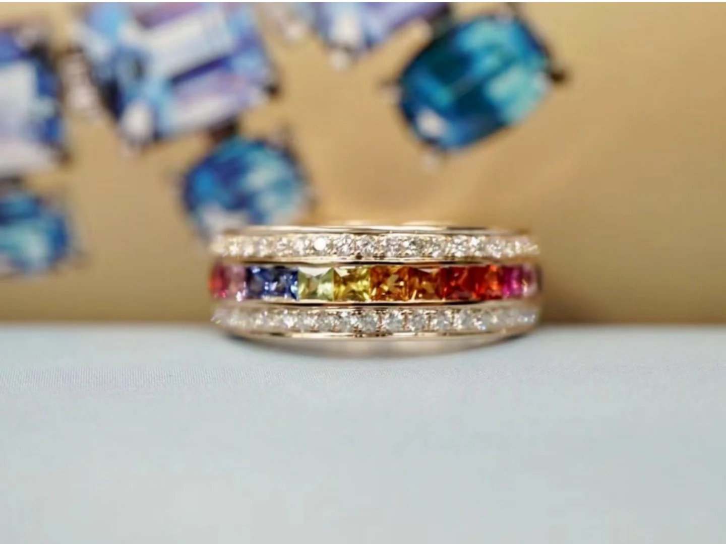 A BH Jewelry setter working a rainbow sapphire and diamond ring on the bench in the Shenzhen workshop