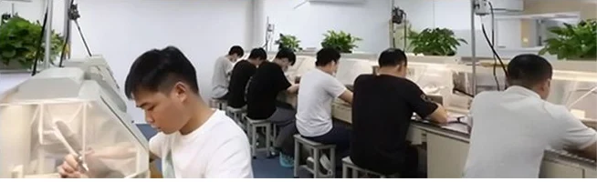 Production employees at the assembly benches in the Guangzhou workshop