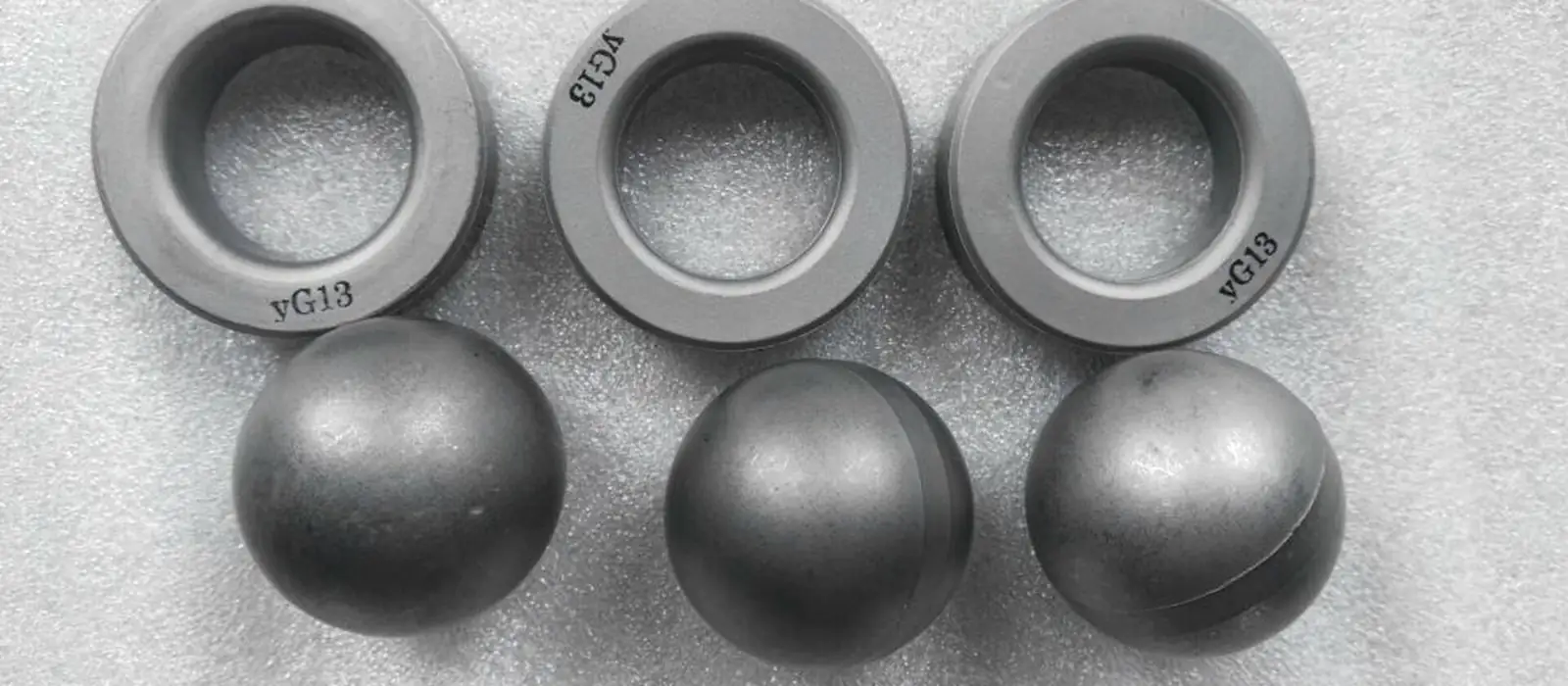 Tungsten carbide ball and seat valve pairs for oil well pumps