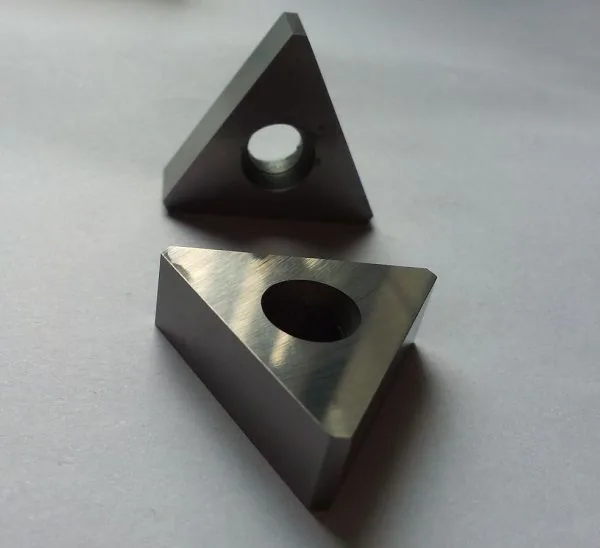 Triangular carbide insert with central clamping bore
