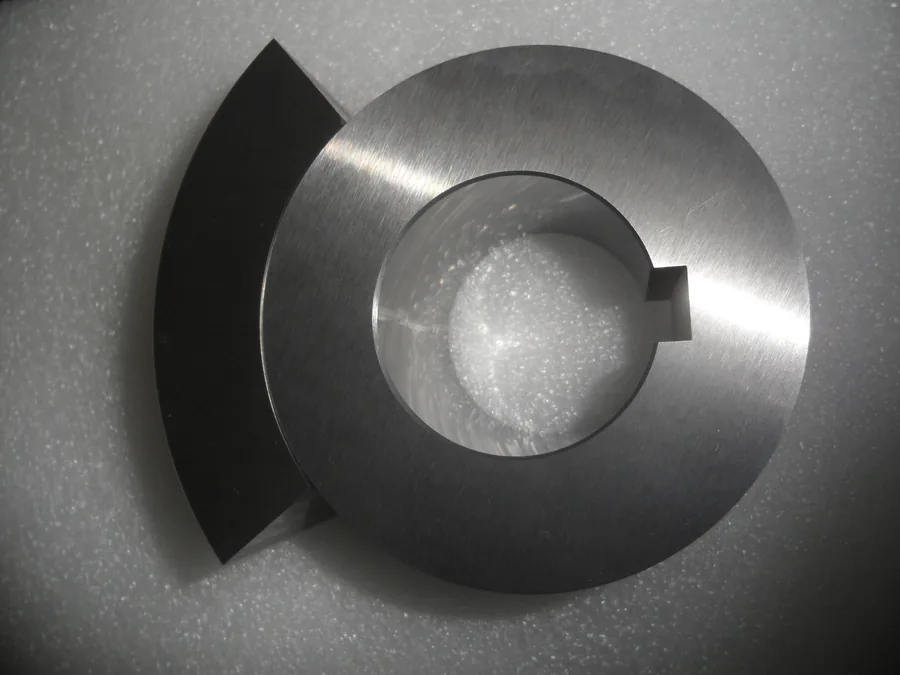 Large machined tungsten carbide ring with keyway and one of the four matching segments