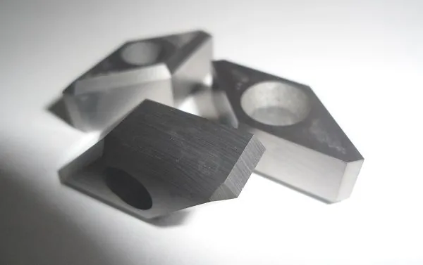 Carbide insert blanks with ground rake face