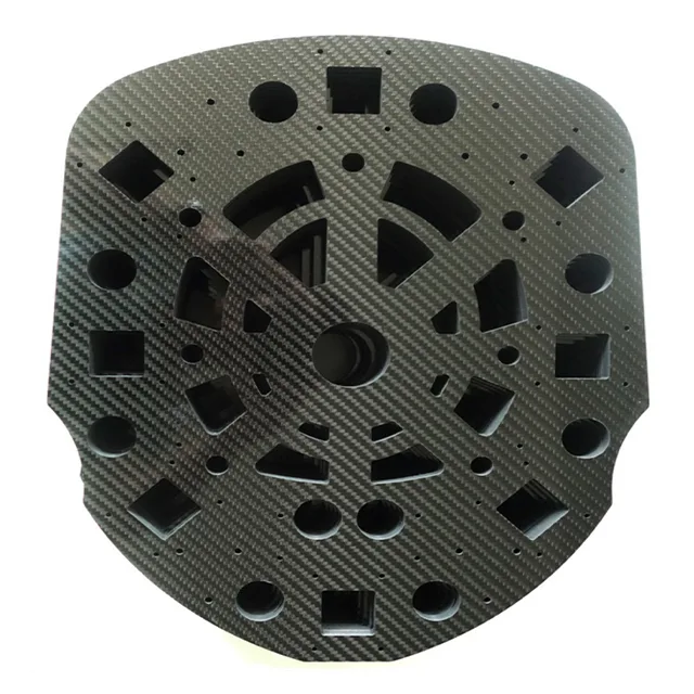 Stacked carbon fiber sheets showing the 3K twill weave surface