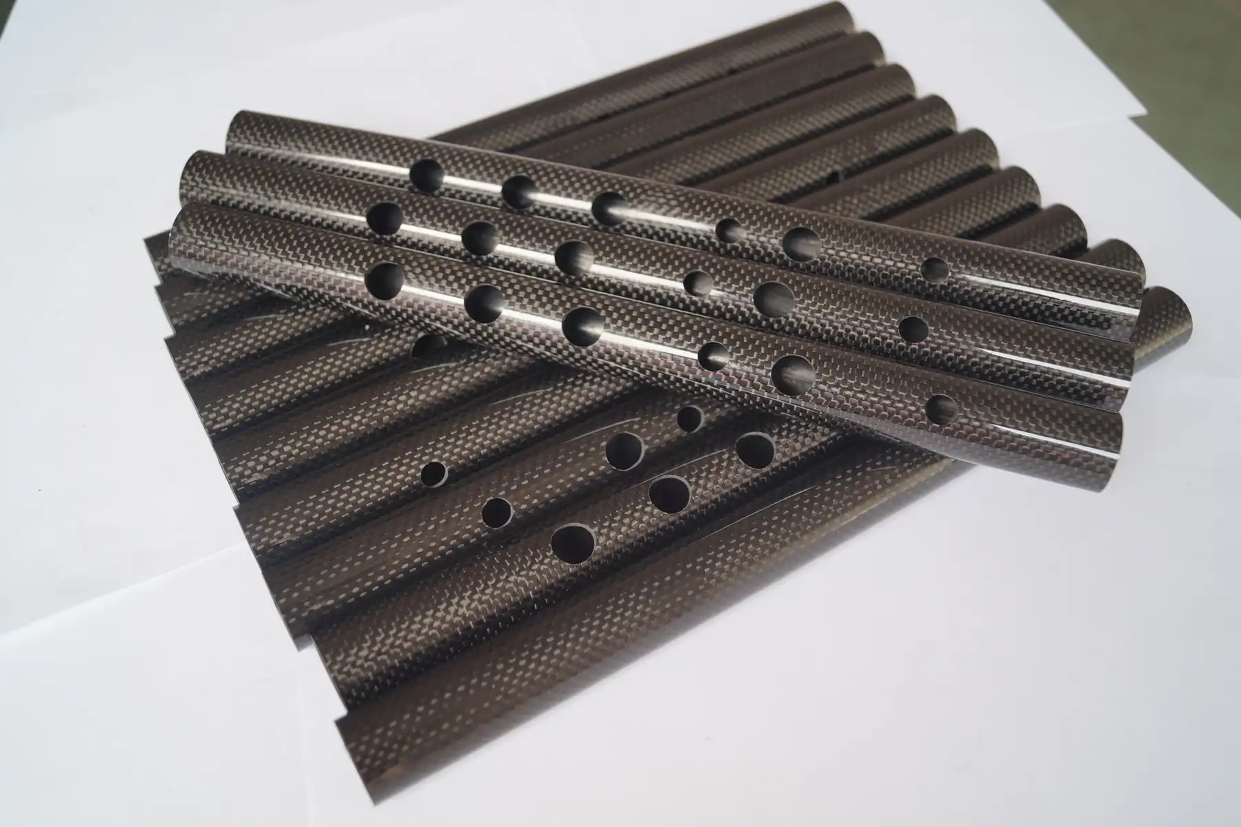 Stock carbon fiber tubes and plates stacked together